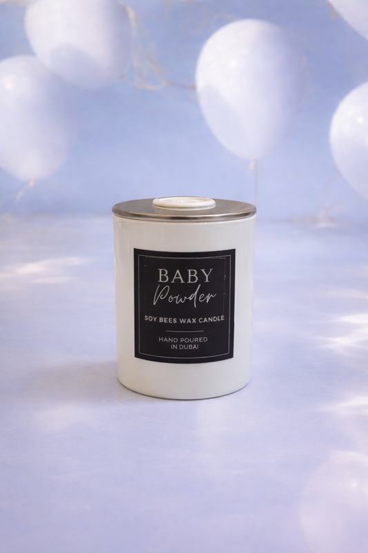 Candle labeled 'Baby Powder' with a soft light background
