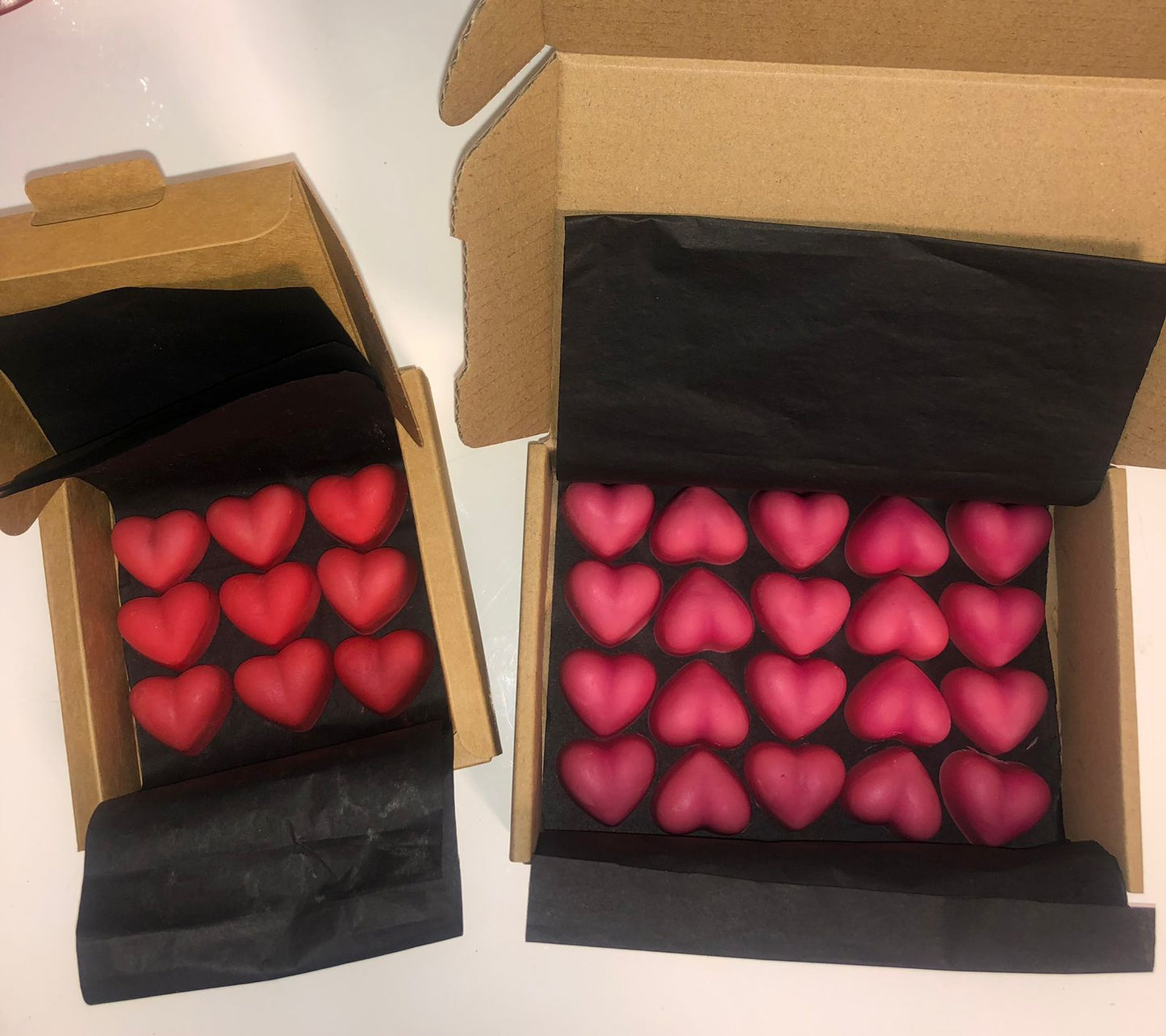 Box of red/dark pink soy, bees wax heart melts. Rose and Oud scented.